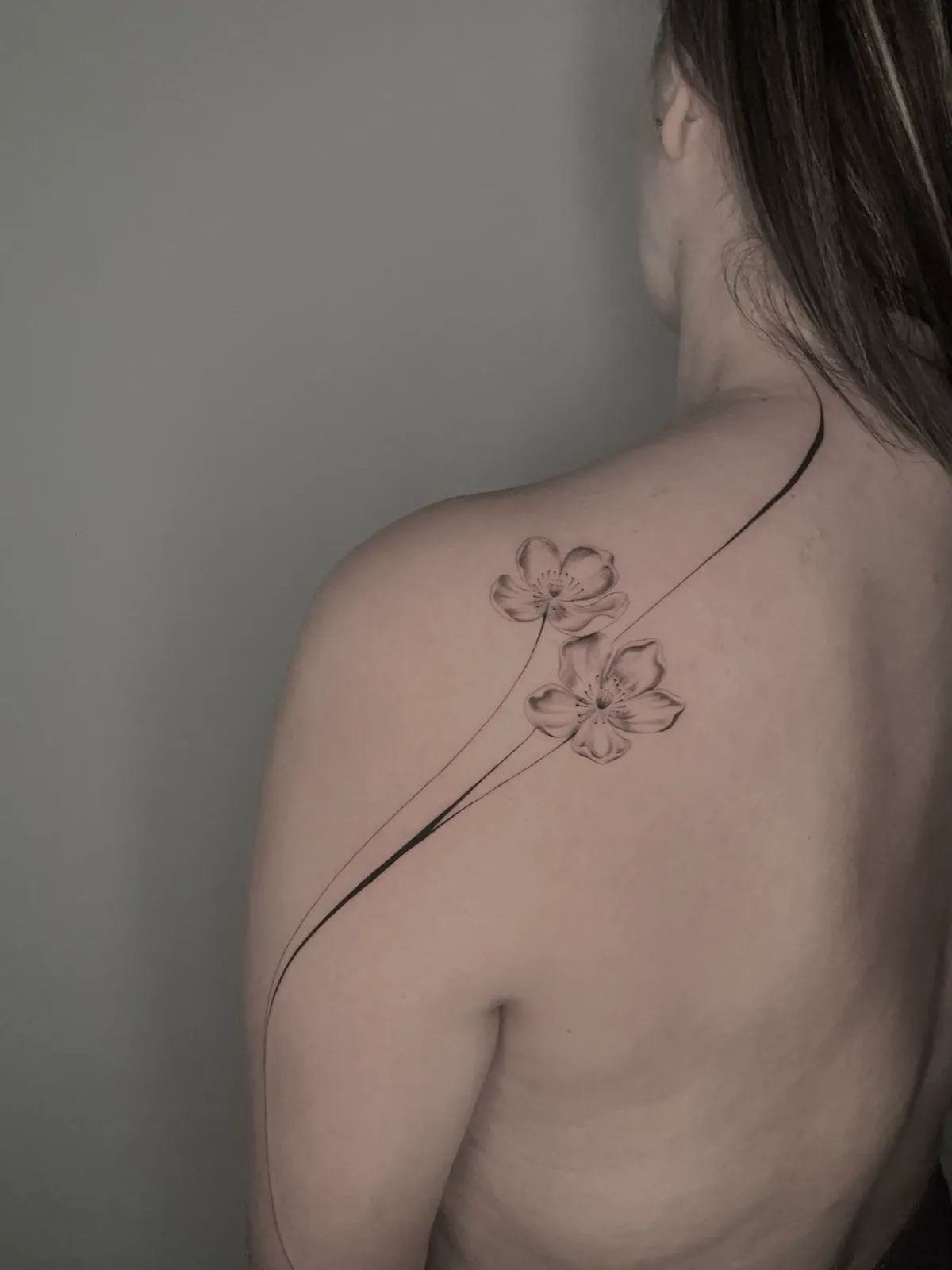 Fine-line flowers flowing over the shoulder and back, healed, GAR Tattoo