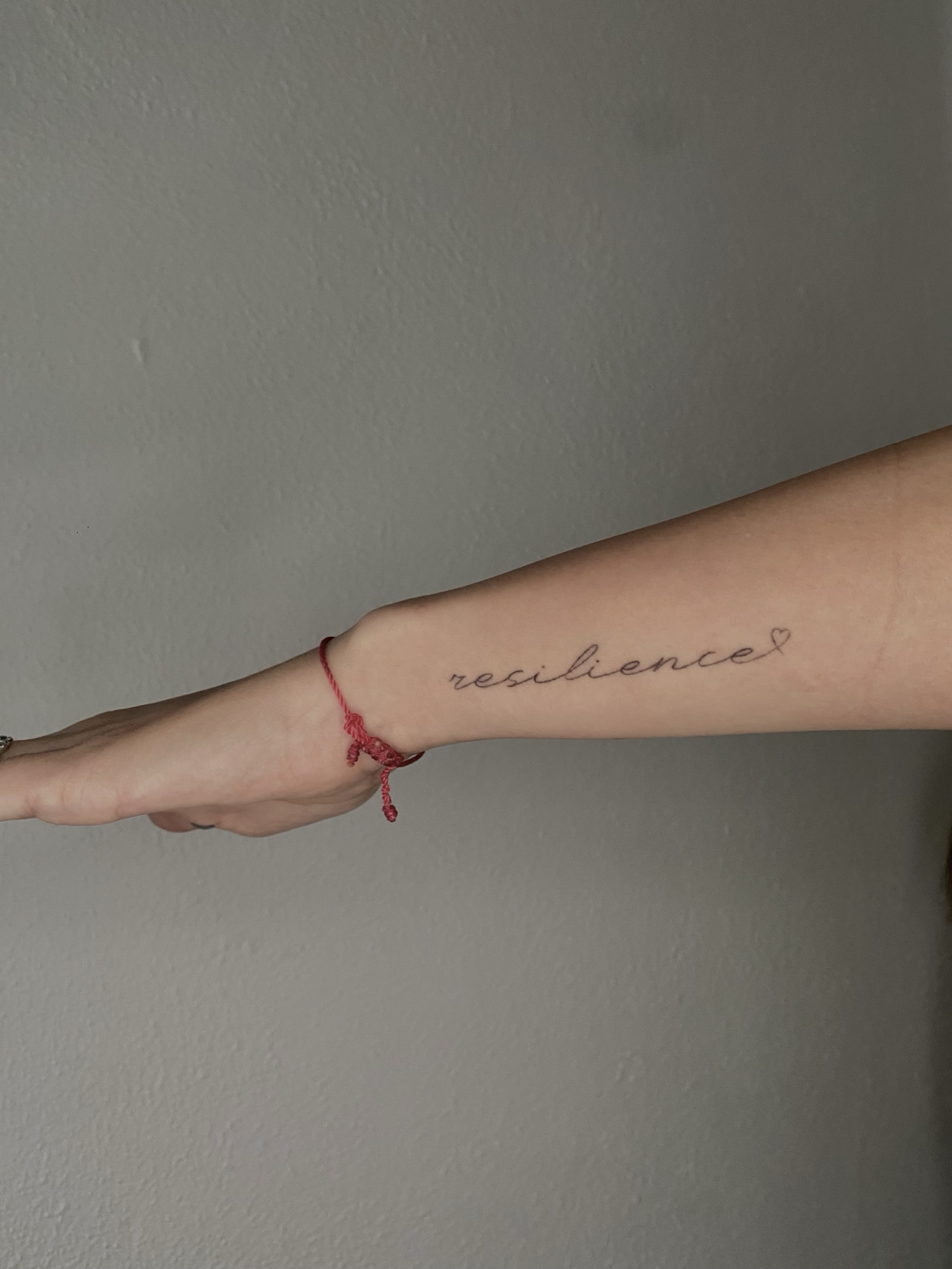 Healed fine-line script reading resilience on the inner forearm, GAR Tattoo
