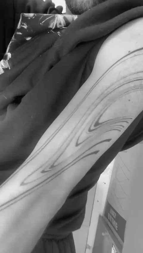 Healed liquid blackwork arm piece shown in motion, GAR Tattoo