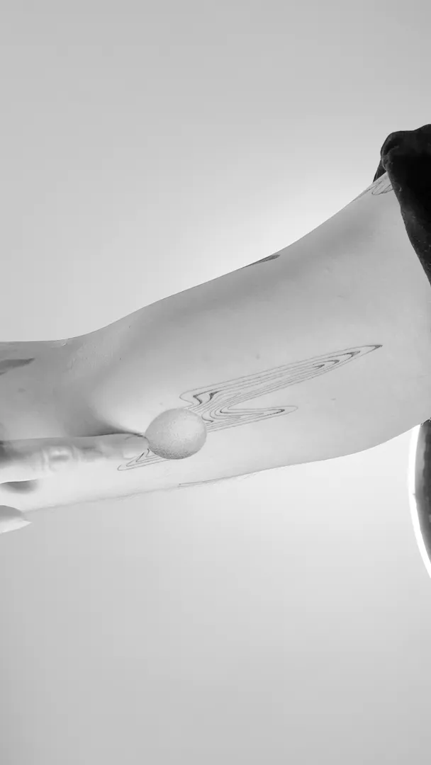 Healed fine-line forearm piece shown in motion, GAR Tattoo